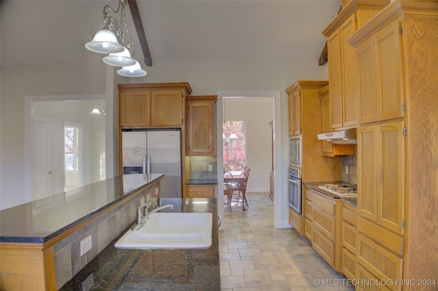 kitchen with decorative light fixtures, decorative backsplash, sink, and appliances with stainless steel finishes