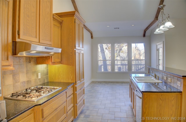 kitchen featuring sink, stainless steel gas cooktop, white dishwasher, pendant lighting, and decorative backsplash