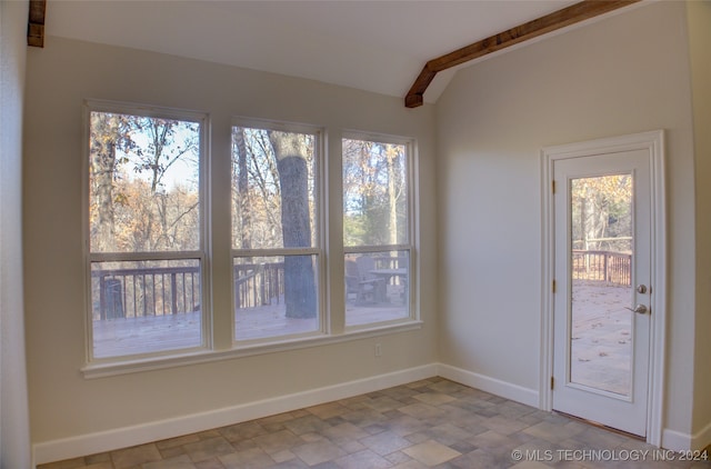 interior space featuring lofted ceiling with beams and a healthy amount of sunlight