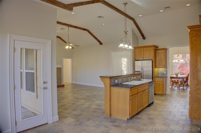 kitchen featuring beamed ceiling, appliances with stainless steel finishes, a center island, and ceiling fan with notable chandelier