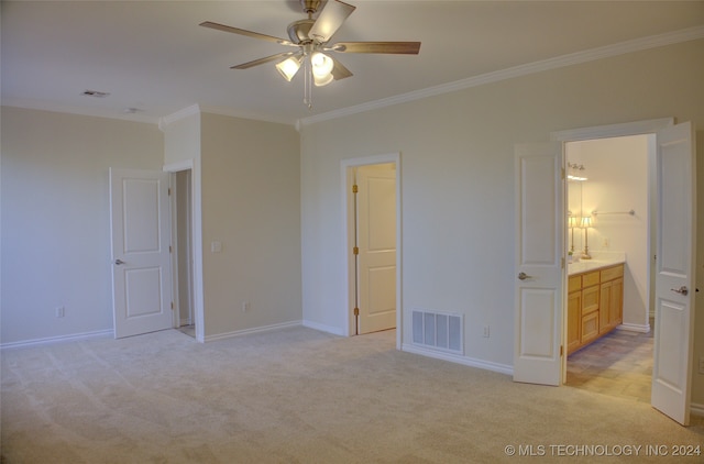 unfurnished bedroom with connected bathroom, ceiling fan, crown molding, and light colored carpet