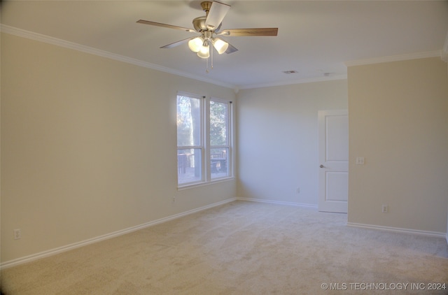 unfurnished room with light colored carpet, ceiling fan, and crown molding