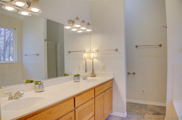 bathroom featuring vanity and a shower with door