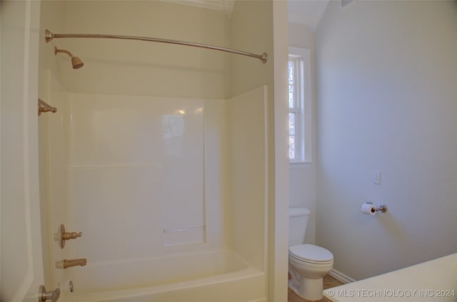 bathroom with washtub / shower combination and toilet