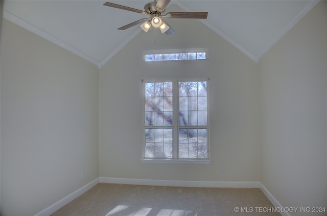 carpeted spare room with vaulted ceiling, a wealth of natural light, and ornamental molding