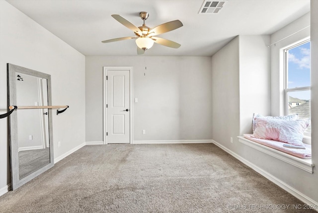 carpeted empty room featuring ceiling fan