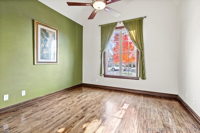 spare room with ceiling fan and hardwood / wood-style flooring