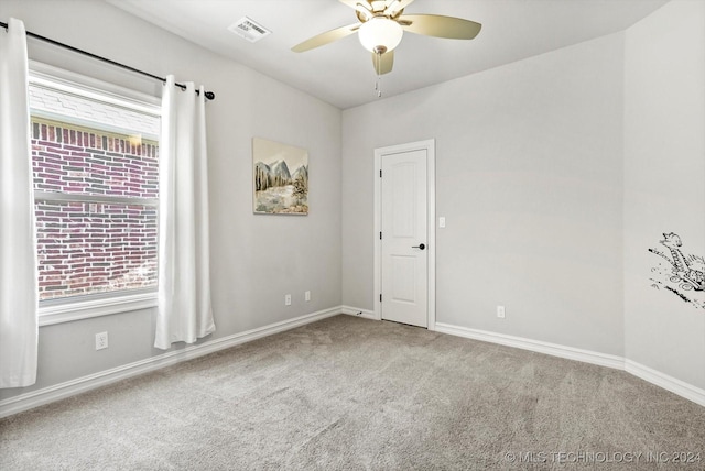 carpeted empty room featuring plenty of natural light and ceiling fan