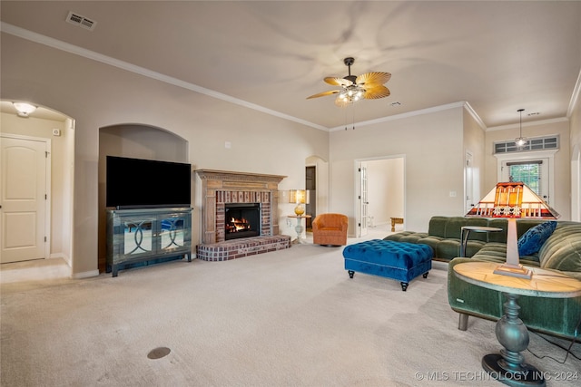 living room featuring carpet, ceiling fan, ornamental molding, and a fireplace