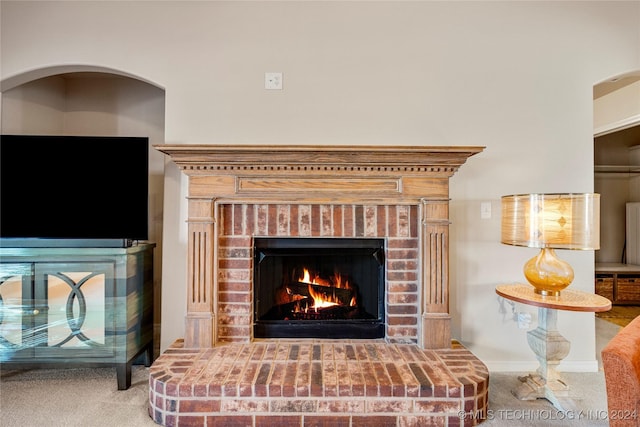 room details with carpet and a brick fireplace