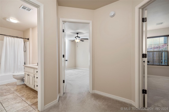 hall with light colored carpet