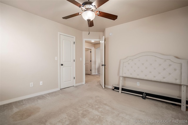 unfurnished bedroom with ceiling fan, light carpet, and a baseboard radiator