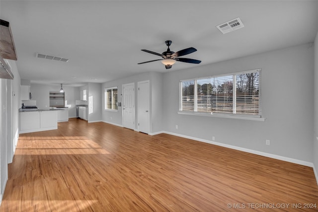 unfurnished living room featuring light hardwood / wood-style floors and ceiling fan