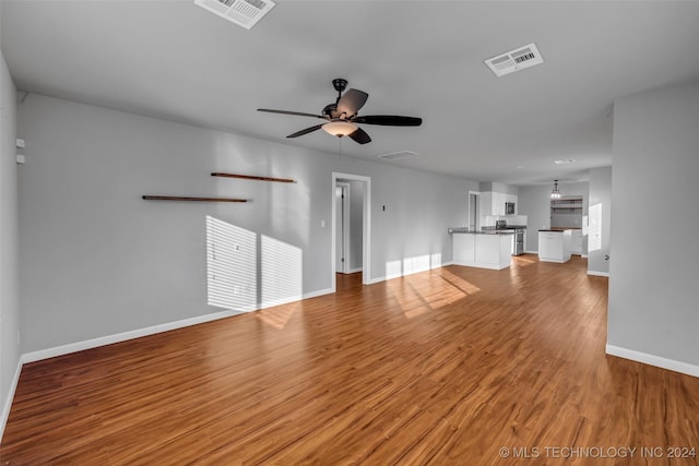 unfurnished living room with light hardwood / wood-style flooring and ceiling fan