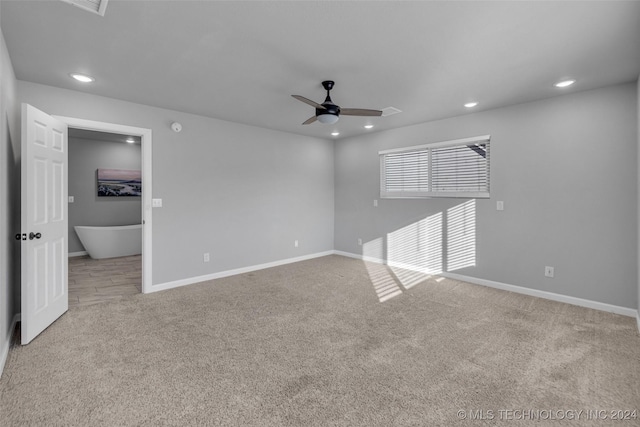 unfurnished living room featuring ceiling fan and light colored carpet