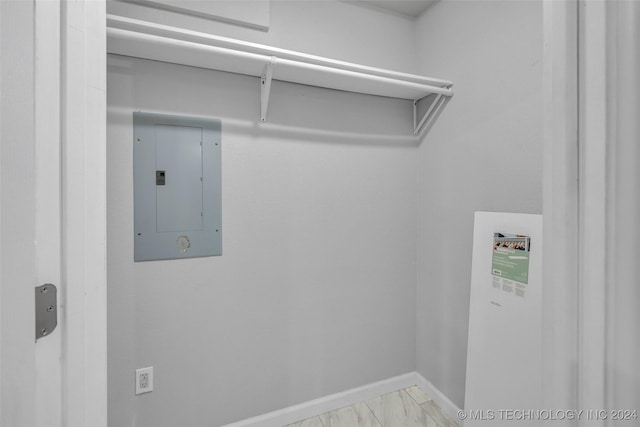 clothes washing area featuring electric panel