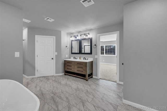 bathroom featuring a tub to relax in and vanity