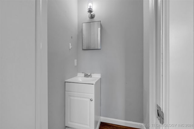 bathroom with hardwood / wood-style flooring and vanity