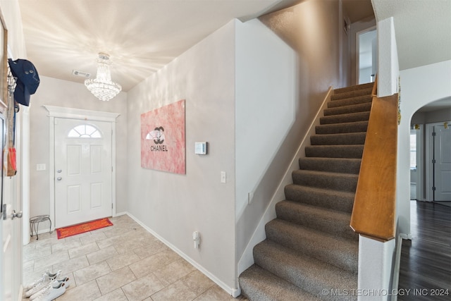 foyer featuring light hardwood / wood-style flooring, an inviting chandelier, and plenty of natural light