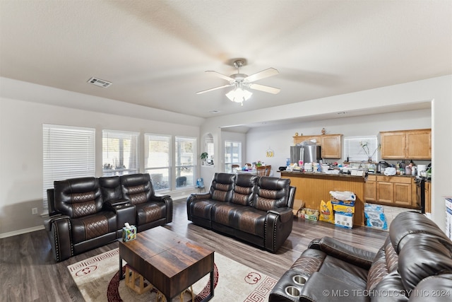 living room featuring ceiling fan and hardwood / wood-style flooring