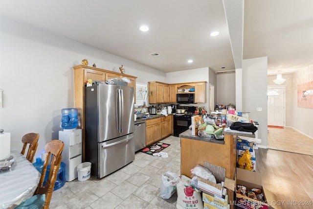 kitchen with sink, light wood-type flooring, and black appliances