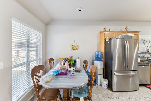 tiled dining area with vaulted ceiling