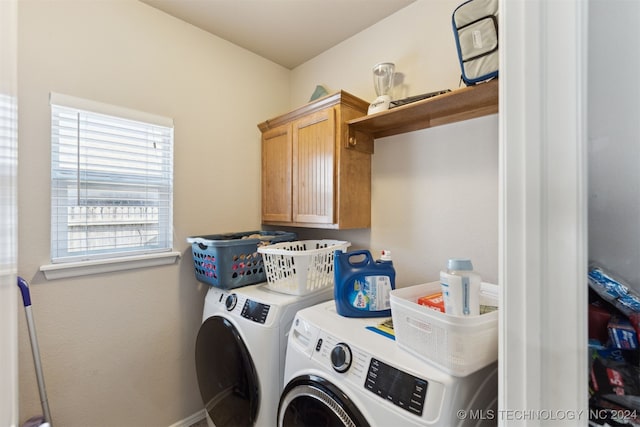 laundry room featuring cabinets and washing machine and clothes dryer