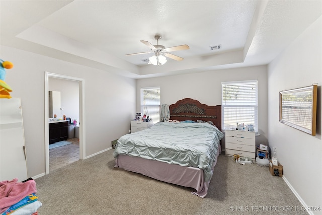 bedroom featuring multiple windows, ceiling fan, and light colored carpet