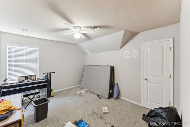 interior space with ceiling fan, light colored carpet, and vaulted ceiling