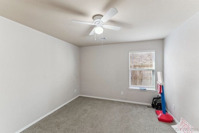 empty room featuring ceiling fan and carpet floors