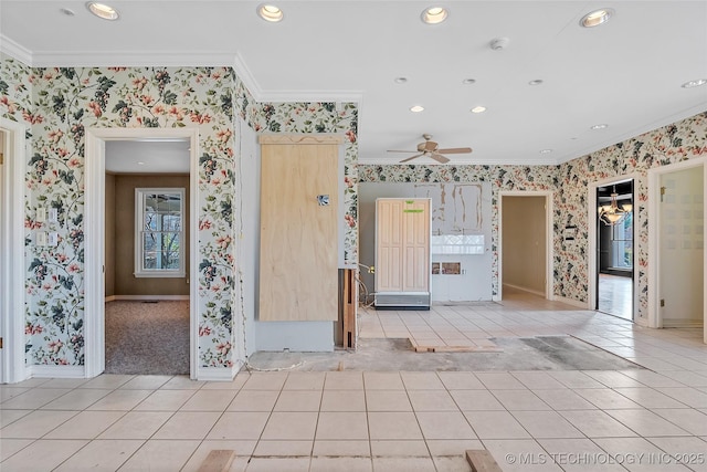 spare room with ceiling fan, light tile patterned floors, and ornamental molding