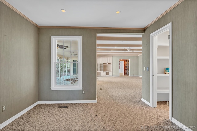 corridor featuring crown molding, beam ceiling, and carpet