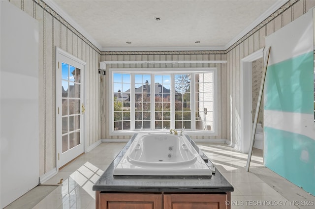 bathroom featuring tile patterned floors, crown molding, and a bathing tub