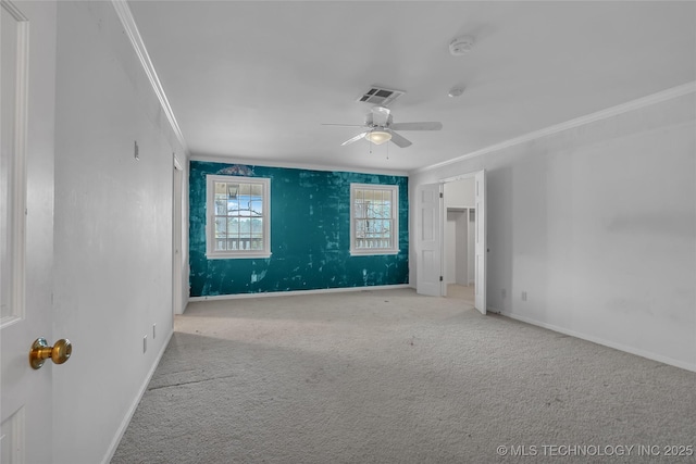 spare room with ceiling fan, light colored carpet, and ornamental molding