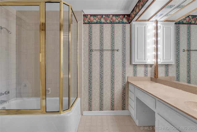 bathroom with vanity and combined bath / shower with glass door