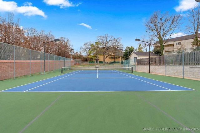 view of tennis court with basketball hoop