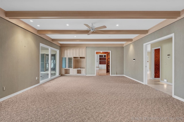 unfurnished living room featuring ceiling fan, beamed ceiling, and carpet flooring