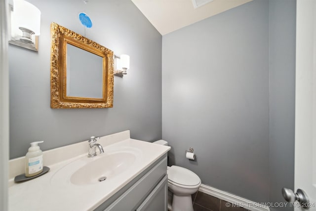 bathroom with tile patterned floors, vanity, and toilet