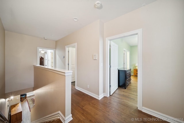 hall with hardwood / wood-style floors