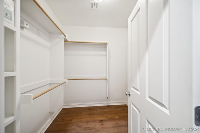 spacious closet featuring dark hardwood / wood-style floors