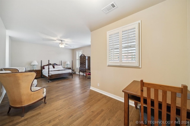 bedroom featuring hardwood / wood-style flooring, multiple windows, and ceiling fan