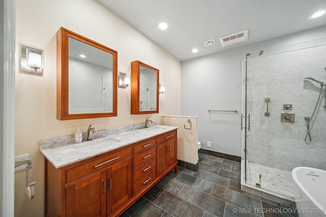 full bathroom with plus walk in shower, vanity, and toilet