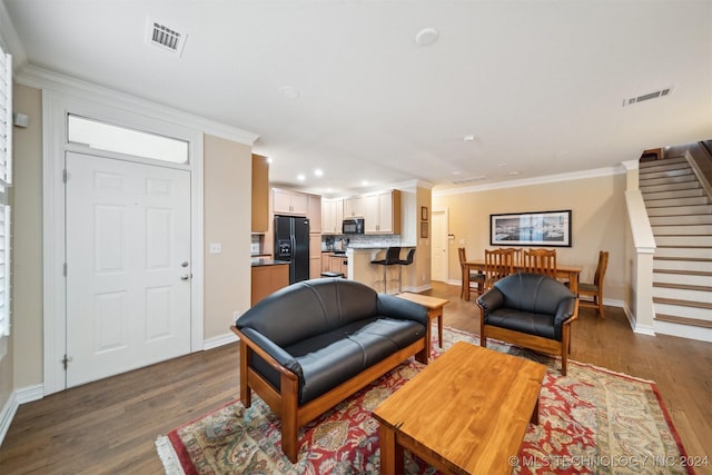 living room with dark hardwood / wood-style floors and ornamental molding