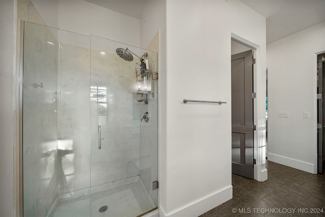 bathroom featuring a shower with door