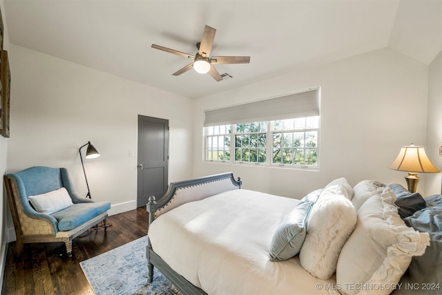 bedroom with ceiling fan, dark wood-type flooring, and lofted ceiling