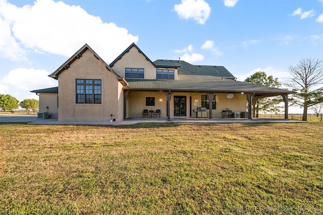 back of house with a lawn, cooling unit, and a patio