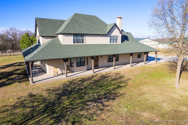 back of house featuring a yard and a patio area