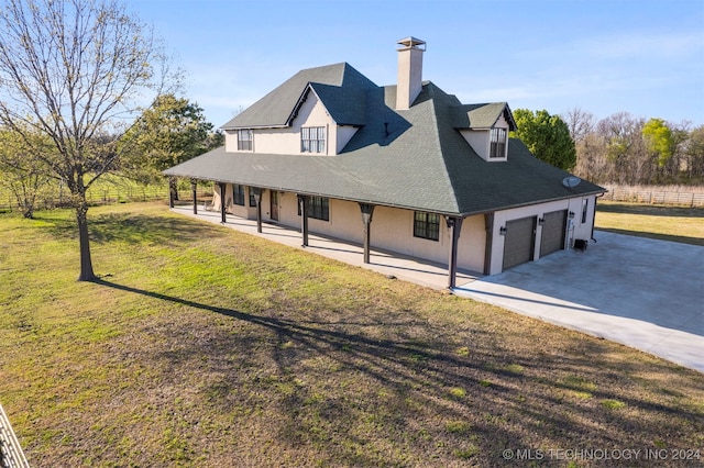 exterior space with a yard, a porch, and a garage