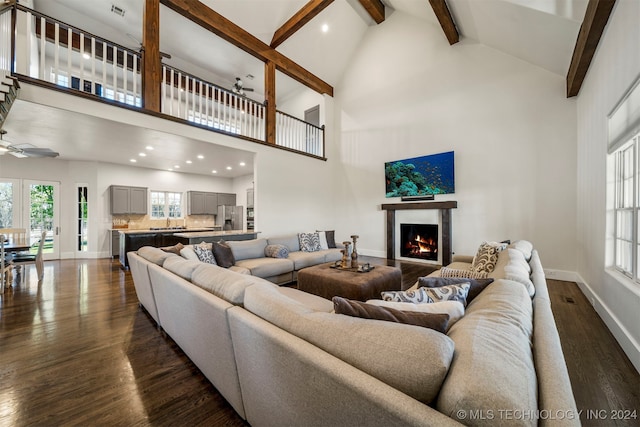 living room featuring beamed ceiling, ceiling fan, dark wood-type flooring, and high vaulted ceiling