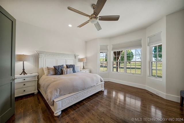 bedroom with dark hardwood / wood-style floors and ceiling fan